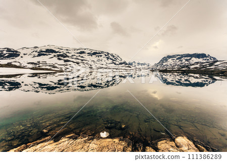 Norway scenic mountains with frozen lake. 111386289