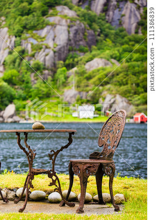 Coffee table with chair outdoor near lake 111386839