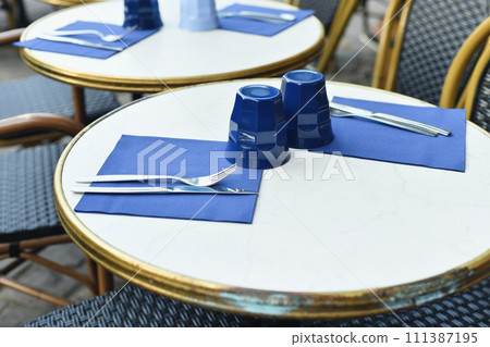 Traditional Parisian small outside cafe with chairs Traditional Parisian small outside cafe with chairs 111387195