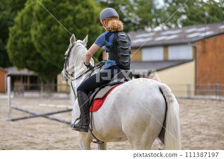 Rider in protective corset for the spine 111387197