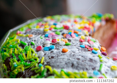 Traditional easter holiday table served with homemade easter cake . A cake with sprinkles on it is decorated with colorful sprinkles. High quality photo Traditional easter holiday table served with homemade easter cake . A cake with sprinkles on it is decorated with colorful sprinkles. High quality photo 111387202