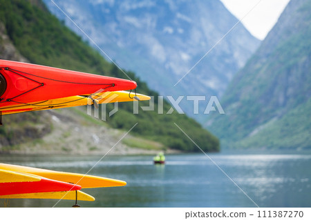 Many canoes on norwegian fjord shore Many canoes on norwegian fjord shore 111387270