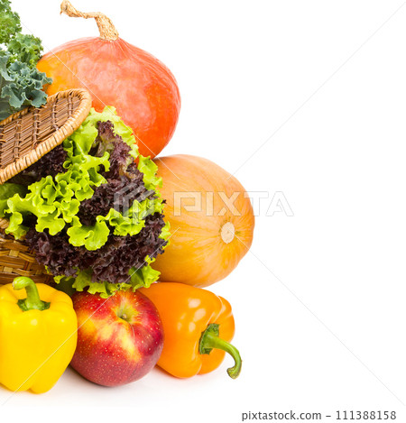 Set of vegetables and fruits in a wicker basket isolated on a white. There is free space for text. 111388158
