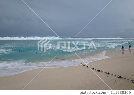 [Guam] Sandy beach hit by high waves due to bad weather 111388369
