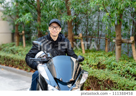A man riding a motorcycle A man riding a motorcycle 111388458
