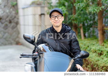 A man riding a motorcycle A man riding a motorcycle 111388460