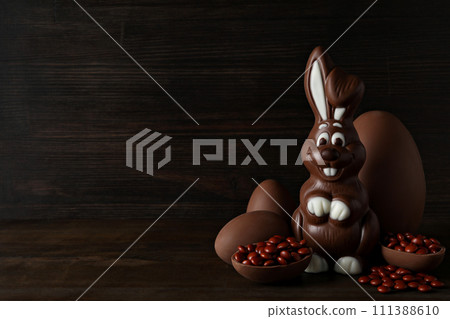 Chocolate eggs with a chocolate rabbit on a dark background 111388610