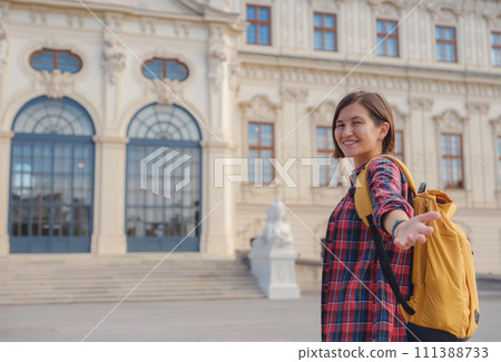 Female tourist traveling in Austria, capital city Vienna. summer female solo trip to Europe, happy young woman walking in park near Belvedere palace complex in Baroque style. Female tourist traveling in Austria, capital city Vienna. summer female solo trip to Europe, happy young woman walking in park near Belvedere palace complex in Baroque style. 111388733