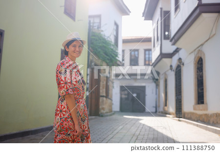 female summer travel to Antalya, Turkey. young asian woman in red dress walk through old town Kalechi , female tourist traveler discover interesting places and popular tourist attraction female summer travel to Antalya, Turkey. young asian woman in red dress walk through old town Kalechi , female tourist traveler discover interesting places and popular tourist attraction 111388750