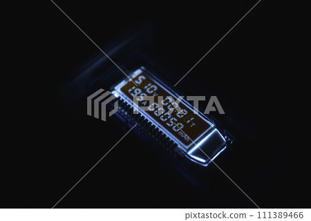 USB measuring device. The electrical meter of the USB devices. The screen of the device in the night. 111389466