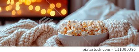 A cozy movie night at home with a selection of classic romantic films and white appetizers. 111390356