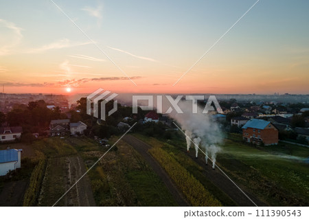 Aerial view of agricultural waste bonfires from dry grass and straw stubble burning with thick smoke polluting air during dry season on farmlands causing global warming and carcinogen fumes 111390543