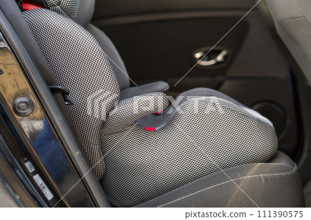 Close-up of child mobile comfortable chair seat in car interior. Transportation, design, security, safety and life protection concept. Close-up of child mobile comfortable chair seat in car interior. Transportation, design, security, safety and life protection concept. 111390575