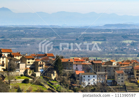 Aerial view of dense historic center of Thiers town in Puy-de-Dome department, Auvergne-Rhone-Alpes region in France. Rooftops of old buildings and narrow streets 111390597