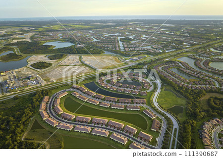 View from above of densely built residential houses under construction in closed living clubs in south Florida. American dream homes as example of real estate development in US suburbs 111390687