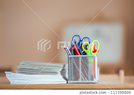 Stack of notebooks and stationery arrangement in classroom or office on copy space background Stack of notebooks and stationery arrangement in classroom or office on copy space background 111390808