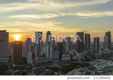 View from above of concrete and glass skyscraper buildings in downtown district of Miami Brickell in Florida, USA at sunset. American megapolis with business financial district at nightfall View from above of concrete and glass skyscraper buildings in downtown district of Miami Brickell in Florida, USA at sunset. American megapolis with business financial district at nightfall 111390848