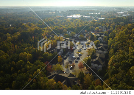View from above of apartment residential condos between yellow fall trees in suburban area in South Carolina. American homes as example of real estate development in US suburbs View from above of apartment residential condos between yellow fall trees in suburban area in South Carolina. American homes as example of real estate development in US suburbs 111391528