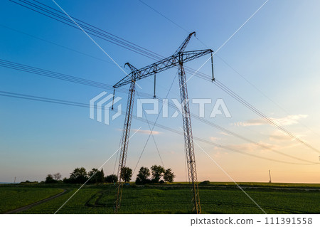 High voltage towers with electric power lines at sunset. 111391558