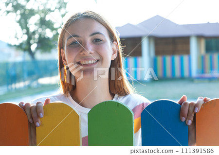 Portrait of pretty happy redhead girl smiling outdoors. Portrait of pretty happy redhead girl smiling outdoors. 111391586