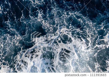 Top down aerial view of sea water surface. White foam waves texture as natural background. 111391683