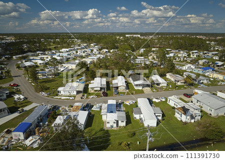 Severely damaged houses after hurricane Ian in Florida mobile home residential area. Consequences of natural disaster Severely damaged houses after hurricane Ian in Florida mobile home residential area. Consequences of natural disaster 111391730