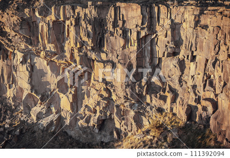 View of Spectacular vertical walls cliffs of Salisbury Crags. 111392094
