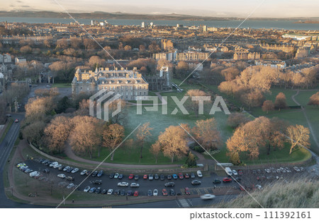 Aerial view of Palace of Holyroodhouse and Holyrood Park seen from the top of Salisbury Crags. 111392161