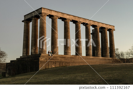 A view of the National Monument of Scotland with a bright blue sky in the background. 111392167