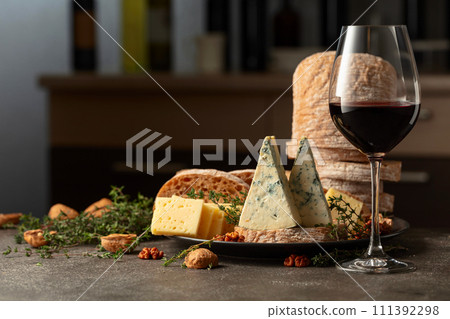 Cheese, bread, walnuts, and thyme on a kitchen table. 111392298