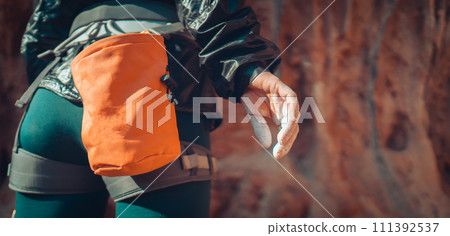 Girl climbs with magnesium powder, hand closeup. Girl climbs with magnesium powder, hand closeup. 111392537