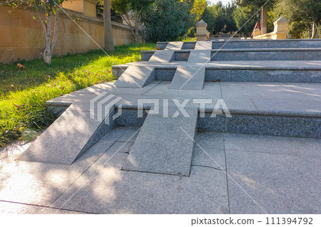 Missing handrails for safe descent or ascent do not allow wheelchair users to climb these stairs. The concept of accessibility for visiting urban public places for everyone 111394792