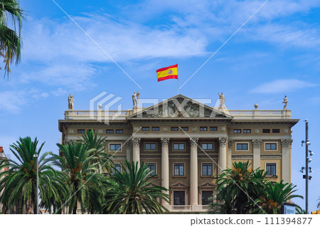 Military Government of Barcelona neoclassical building - Gobierno Militar de Barcelona -with Spanish flag waving on top in Catalonia, Spain. 111394877