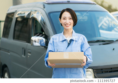 Smiling young woman carrying luggage Smiling young woman carrying luggage 111395727