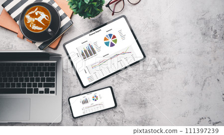 Modern office desk workplace with blank screen digital tablet and smartphone, laptop, eyeglass, notebook and cup of coffee, Top view flat lay with copy space. 111397239