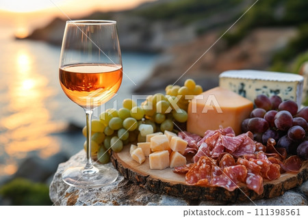 AI-generated content. Picnic served outside with a glass of wine, cheese, grapes, salami on a wooden board in sunlight 111398561