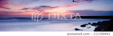 Sunset on a beach 111399942