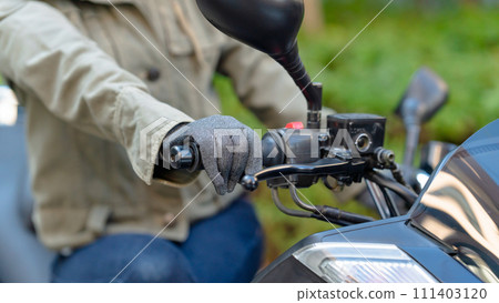 Hands of a woman riding a bike 111403120