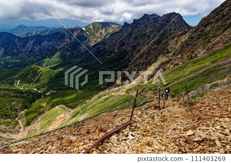 Climbers climbing the Bunzaburo Trail in the Yatsugatake Mountain Range and views of Yokodake and Iodake 111403269