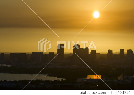 Aerial view of downtown district of Tampa city in Florida, USA at sunset. Dark silhouette of high skyscraper office buildings in modern american midtown 111403795