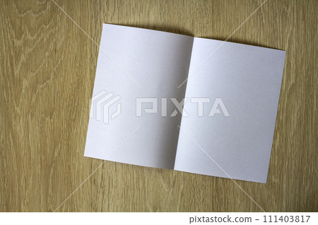 Blank white piece of paper on wooden background Blank white piece of paper on wooden background 111403817