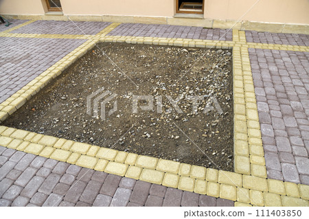 Installation of stone paving slabs in a yard. Installation of stone paving slabs in a yard. 111403850