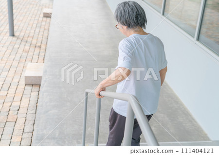 Elderly women going up and down stairs in rehabilitation (locomo, frailty, sarcopenia, osteoporosis) 111404121
