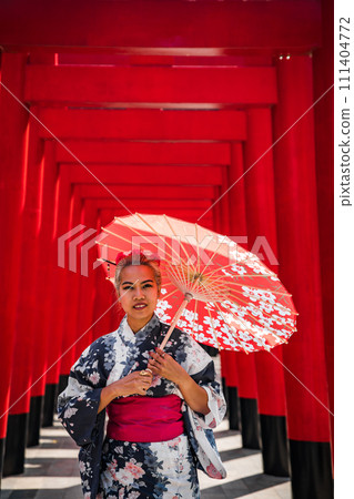 Asian girl in kimono and umbrella in Japanese theme park Hinoki Land in Chai Prakan District, Chiang 111404772