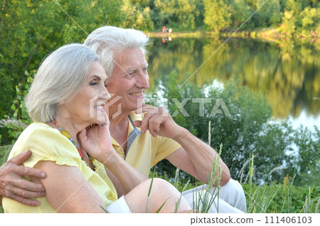 Portrait of beautiful elderly couple together in park 111406103