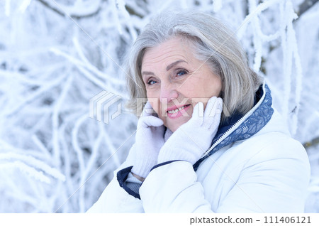 Happy old woman in a fur coat in the winter. Happy old woman in a fur coat in the winter. 111406121