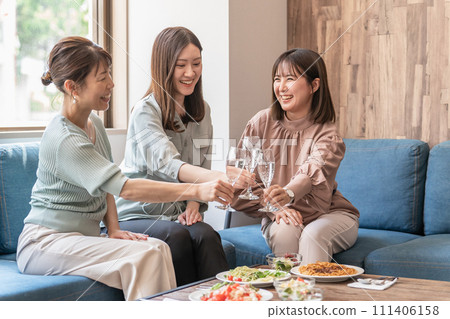 Mom friends, colleagues, and female friends toasting at a girls' night out, lunch, party, or home party Mom friends, colleagues, and female friends toasting at a girls' night out, lunch, party, or home party 111406158