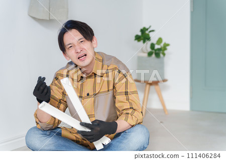 Middle-aged man assembling furniture Middle-aged man assembling furniture 111406284