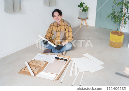 Middle-aged man assembling furniture Middle-aged man assembling furniture 111406285