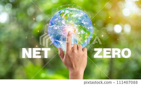 Hand of human pointing to earth and Net Zero icon, carbon neutral and net zero concept for net zero greenhouse gas emissions target, Climate neutral long term strategy, natural background. Hand of human pointing to earth and Net Zero icon, carbon neutral and net zero concept for net zero greenhouse gas emissions target, Climate neutral long term strategy, natural background. 111407088